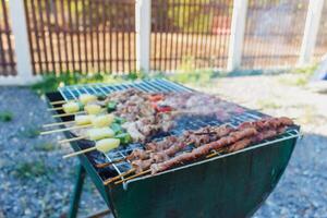Blurred image,Barbecue BBQ skewered on a charcoal grill is a street food that is convenient for a party or picnic and barbecue BBQ is also increasing its popularity in many countries. photo