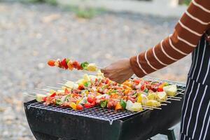 Blurred image,Barbecue BBQ skewered on a charcoal grill is a street food that is convenient for a party or picnic and barbecue BBQ is also increasing its popularity in many countries. photo