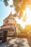Smooth Focus, A young Asian female tourist is happily walking around Thailand alone admiring the beautiful and unique scenery of Thailand. The concept of traveling alone of tourists in Asia photo