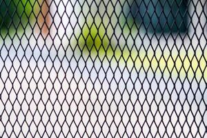 A black iron grate is used as a fence to prevent the dangers of people and poisonous animals entering the area. Steel grating background with Copy Space for inserting text for design and advertising. photo