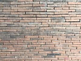 Brick wall background is a wall made of clay bricks, giving the structure strength and cement line between bricks that looks beautiful. It is popular to build a wall of ancient monuments.copy space, photo