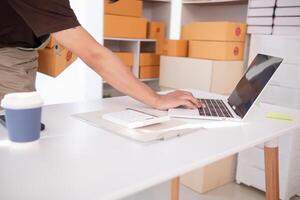 Start Up Business or small SME business owners open an office at home conduct online business and check product stock before sending products according orders customers who order products online. photo