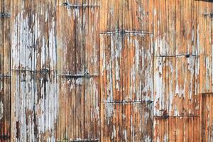 The bamboo wall background is made from the whole bamboo tree and is spread to create the walls of village houses because bamboo is a natural material that can be easily found in the countryside. photo