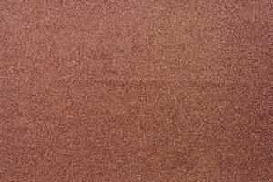 Blurred background of brown sandpaper for inserting text. Sandpaper backgrounds are made from natural materials for polishing wood and steel to a smooth surface before painting. photo