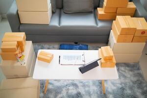 parcel boxes being packaged and ready to be sent to customers who have placed online orders within the online store's system. A small SME businessman has prepared the parcels and is ready for delivery photo
