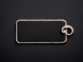Black Paper Price Label With String Isolated on black background. photo