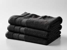 neatly folded black towel isolated on white background. photo
