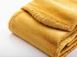 neatly folded golden yellow towel isolated on white background. photo