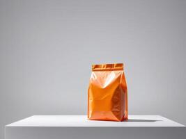 Orange paper doypack placed on podium on empty background. photo