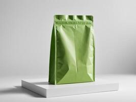 Green paper doypack placed on podium on empty background. photo