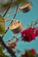 Soaring above the city, the ferris wheel's graceful dance invites us to find wonder in the ordinary. Glimpse the world from a new perspective - where thrills and tranquility intertwine. photo