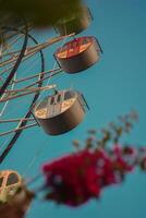 Reaching for the sky, one gondola at a time. The vibrant colors of this Ferris wheel beckon us to embrace the wonder of new perspectives. photo