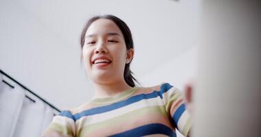 Handheld low angle view shot, Happy young woman open a cardboard box to look at the items she moved from old home. Moving house and lifestyle concept. video