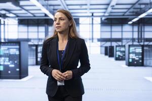 System administrator in data center identifying and solving technical issues related to data center infrastructure. IT expert managing, maintaining and securing high tech server hub environment photo