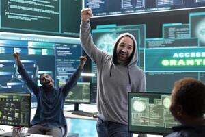 Group of professional hackers gaining access into government database to steal important information for hybrid warfare. Experts work on scams and phishing activity in high tech office. photo