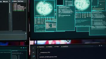 Close up of code running on computer displays in empty apartment used by hacker stealing secrets. Illegal scripts on PC screens used by spy infiltrating governments, handheld camera shot photo