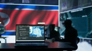 Military personnel working next to AI brain neural network in a command post with a North Korea flag on big screen. IT engineer employing deep learning to spread misinformation for scams. Camera B. photo
