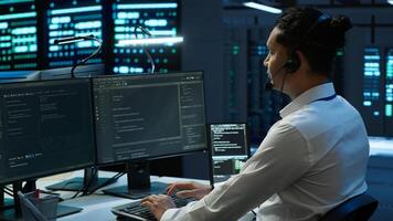 Data center agent providing logistics support to businesses and overseeing infrastructure. Server farm worker oversees hardware rackmounts and communicates with technicians, camera A photo