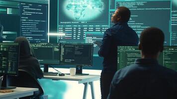 Governmental hacking group targeting sensitive information through high tech cyber attacks, digital espionage. Team of IT experts working on national security and data privacy servers. Camera A. photo
