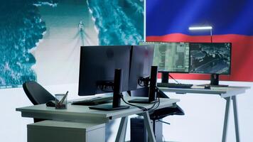 Empty army command post with the russian flag running on big screen, russian federation and government working on propaganda to spread fake news among the population. Camera A. photo