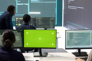 Cyber security experts working with mockup layout on a desktop pc, using encryption and IT security in a governmental agency. Focusing on cyber operations to hack rival states systems. photo