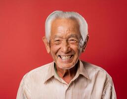 A men with 90 years old looking at the camera with excited facial expression in front of the red background photo