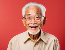 A men with 90 years old looking at the camera with excited facial expression in front of the red background photo