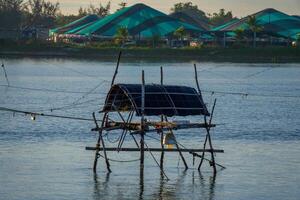 landscape of life and houses next to Thu Bon river in Hoi An ancient town, Quang Nam Province, Vietnam. Hoi An is one of the most popular destinations in Vietnam. photo