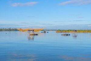 landscape of life and houses next to Thu Bon river in Hoi An ancient town, Quang Nam Province, Vietnam. Hoi An is one of the most popular destinations in Vietnam. photo