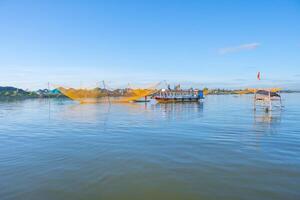 landscape of life and houses next to Thu Bon river in Hoi An ancient town, Quang Nam Province, Vietnam. Hoi An is one of the most popular destinations in Vietnam. photo
