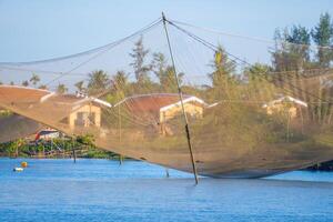 landscape of life and houses next to Thu Bon river in Hoi An ancient town, Quang Nam Province, Vietnam. Hoi An is one of the most popular destinations in Vietnam. photo