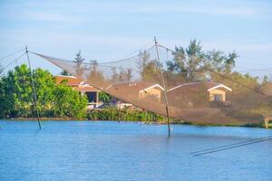 landscape of life and houses next to Thu Bon river in Hoi An ancient town, Quang Nam Province, Vietnam. Hoi An is one of the most popular destinations in Vietnam. photo