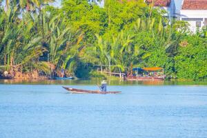 landscape of life and houses next to Thu Bon river in Hoi An ancient town, Quang Nam Province, Vietnam. Hoi An is one of the most popular destinations in Vietnam. photo