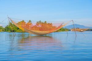landscape of life and houses next to Thu Bon river in Hoi An ancient town, Quang Nam Province, Vietnam. Hoi An is one of the most popular destinations in Vietnam. photo