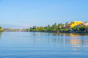 landscape of life and houses next to Thu Bon river in Hoi An ancient town, Quang Nam Province, Vietnam. Hoi An is one of the most popular destinations in Vietnam. photo