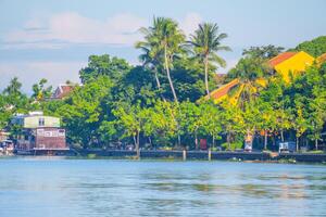 landscape of life and houses next to Thu Bon river in Hoi An ancient town, Quang Nam Province, Vietnam. Hoi An is one of the most popular destinations in Vietnam. photo