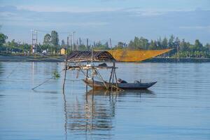 landscape of life and houses next to Thu Bon river in Hoi An ancient town, Quang Nam Province, Vietnam. Hoi An is one of the most popular destinations in Vietnam. photo