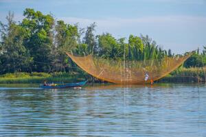 landscape of life and houses next to Thu Bon river in Hoi An ancient town, Quang Nam Province, Vietnam. Hoi An is one of the most popular destinations in Vietnam. photo