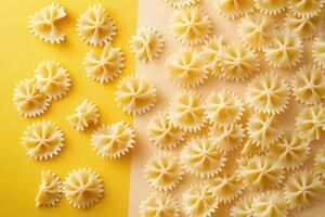 Close-Up of Uncooked Farfalle Pasta on Yellow and Beige Background - Italian Cuisine Concept photo