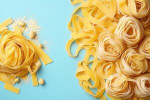 Fresh Homemade Pasta on Light Blue Background - Tagliatelle and Pappardelle Noodles with Flour photo