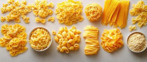 Assorted Italian Pasta Varieties Arranged on a Light Background with Bowls of Grated Cheese photo