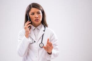 Portrait of doctor who is talking on phone with patient. photo