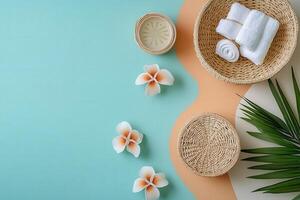 Spa and Wellness Concept with Towels, Flowers, and Palm Leaves on a Pastel Background photo