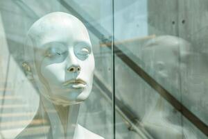 Realistic Display Mannequin in Modern Window Against Urban Backdrop During Daytime photo