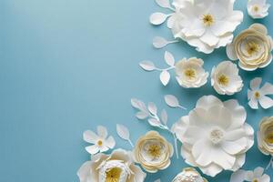 Elegant White Paper Flowers Arranged Artfully on Light Blue Background for Creative Decoration Purposes photo