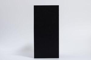 mockup of a black vertical brochure on a white horizontal background photo
