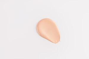 A beautiful sample of foundation powder on a white background. A copy of the space. Upper view. pattern, beige tone texture layout. photo