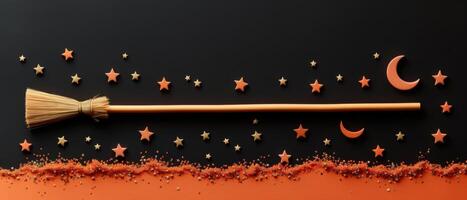 Halloween-Themed Broomstick with Stars and Moon on Black and Orange Background photo