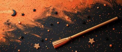 Halloween-Themed Background with Broomstick and Stars on Orange and Black Surface photo