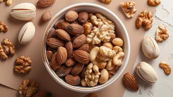 Assorted Nuts in a Bowl - Almonds, Walnuts, Cashews, and Pistachios on a Neutral Background photo